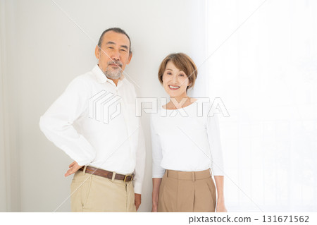 Smiling senior couple standing close together, portrait Smiling senior couple standing close together, portrait 131671562
