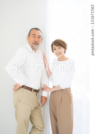 Smiling senior couple standing close together, portrait 131671565