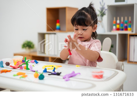toddler girl with sculpting from plasticine 131671633
