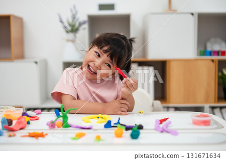 toddler girl with sculpting from plasticine 131671634