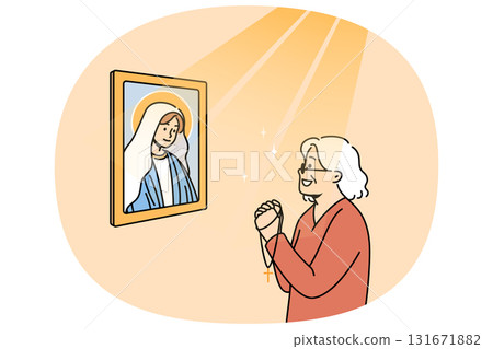 Elderly woman prays to god standing near icon of virgin mary, under rays of light 131671882