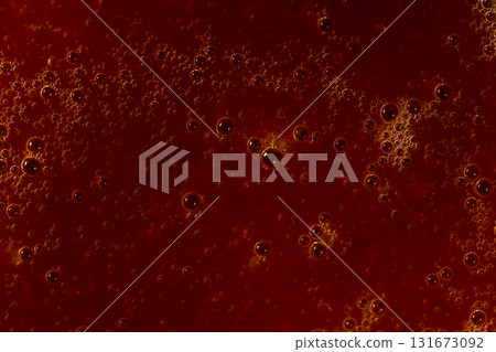 Red liquid texture with bubbles, abstract macro background 131673092