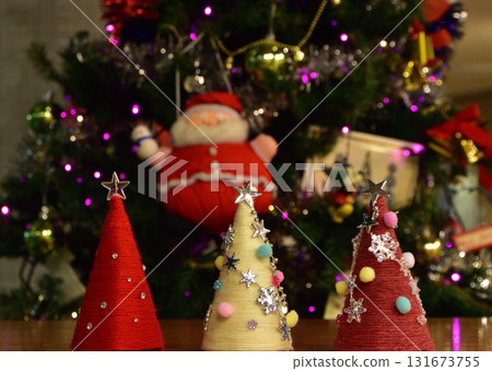 Santa Claus decorating a Christmas tree 131673755