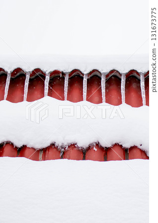 Thick White Snow on Red Roof with Subtle Icicles in Winter Thick White Snow on Red Roof with Subtle Icicles in Winter 131673775