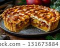 Freshly baked apple pie with a golden crust and a slice removed, showcasing the juicy filling on a rustic wooden table 131673884