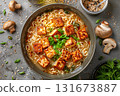 Delicious bowl of ramen with crispy tofu cubes and fresh scallions on a grey stone surface, garnished with sesame seeds and mushrooms 131673887