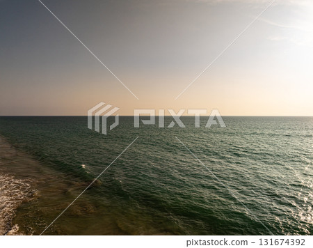 Beautiful sky sunset or sunrise clouds over sea nature background Beautiful sky sunset or sunrise clouds over sea nature background 131674392