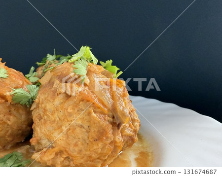 Meatballs with rice and onions simmered in tomato sauce. Delicious and healthy home cooking. 131674687