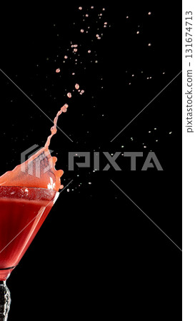 Red martini splash with elegant glass and scattered droplets Red martini splash with elegant glass and scattered droplets 131674713
