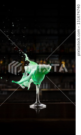 Green creamy cocktail splash in elegant bar interior with foam motion Green creamy cocktail splash in elegant bar interior with foam motion 131674740