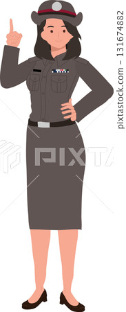 thai female police officer in uniform standing and pointing upward for public awareness or education concept 131674882