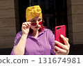 Happy adult asian with extravagant style with phone 131674981