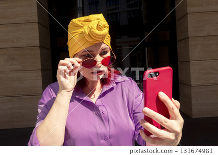 Happy adult asian with extravagant style with phone Happy adult asian with extravagant style with phone 131674981
