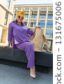 woman with craft shopping bags in the city. The concept of fashionable Consumerism and ecology.  131675006