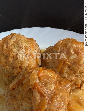 Meatballs with rice and onions simmered in tomato sauce. Delicious and healthy home cooking. Meatballs with rice and onions simmered in tomato sauce. Delicious and healthy home cooking. 131675043