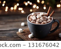 Cup of hot chocolate with marshmallows and cinnamon sticks on rustic wooden table, Christmas lights blurred in background 131676042