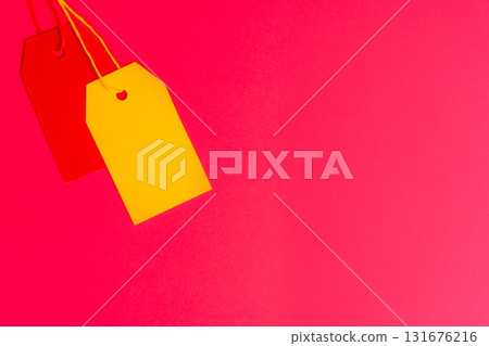 Red and yellow price tags on pink background with copy space Red and yellow price tags on pink background with copy space 131676216
