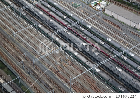 A view of the rails and train cars parked on the tracks from a tall building A view of the rails and train cars parked on the tracks from a tall building 131676224