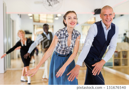 Man and woman performing jazz dance in dancing room 131676540