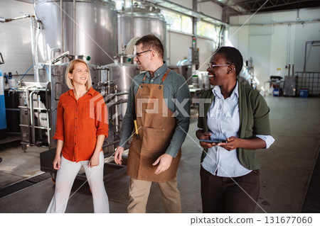 People walking and talking in brewery production facility People walking and talking in brewery production facility 131677060
