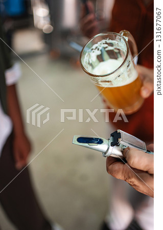 Measuring beer quality with a refractometer in a brewery 131677067