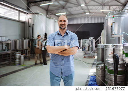 Craft beer brewer smiling in his small brewery 131677077