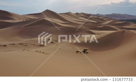 Aerial view of sand dunes in desert at sunset 131677733