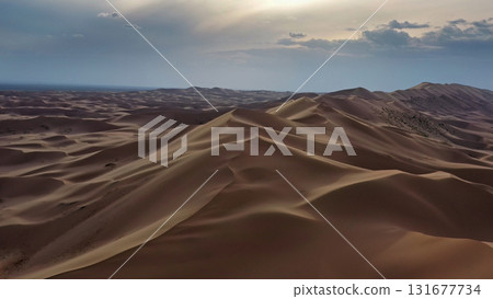 Aerial view of sand dunes in desert at sunset Aerial view of sand dunes in desert at sunset 131677734