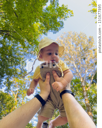 Joyful Baby Lifted in Forest 131677895