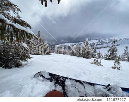 Snowboard on Snowy Mountain Slope 131677917