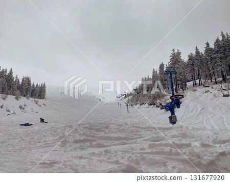 Skiers on Snowy Slope with Ski Lift 131677920