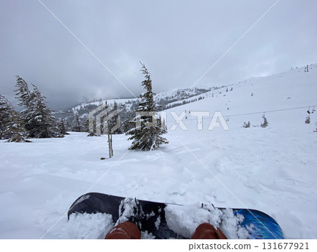 Snowboard on Snowy Mountain Slope 131677921