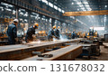 Welding metal frame in workshop, industrial workers wearing protective gear. Men with protective goggles welding in factory creating sparks and smoke in dimly lit industrial setting. 131678032