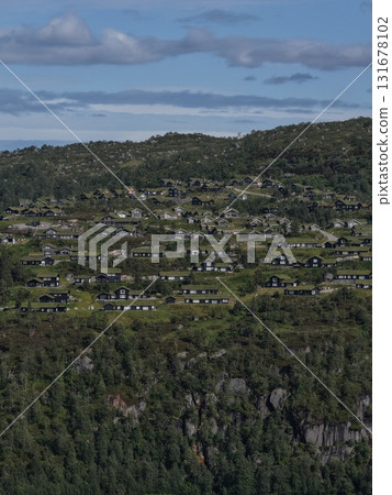 Village houses built into green rugged hillside landscape Village houses built into green rugged hillside landscape 131678102