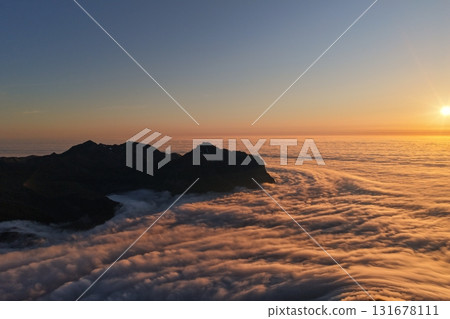Sunrise glowing above mountain peaks and a sea of clouds, Switzerland 131678111