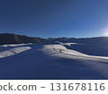 Solo adventurer hiking through snowy winter mountain landscape, Kazakhstan 131678116