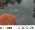 Person rowing boat on lake among autumn trees, Kazakhstan 131678120