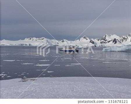 Expedition ship navigating icy waters in antarctica 131678121