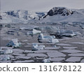 Antarctica ocean with scattered icebergs and mountains 131678122
