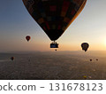 Hot air balloons flying over city at sunrise 131678123