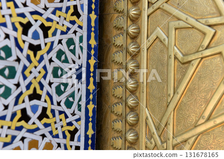 Brass door with Arabic calligraphy and Moroccan zellij mosaic tilework. Royal Palace, Fez, Morocco 131678165
