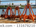 Grab buckets for port work Heavy machinery lined up on the quay at Nagoya Port 131678210
