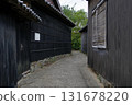 A quiet alley leading to the black-walled village of Sakushima 131678220