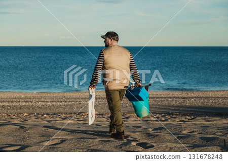 Fisherman Arriving At The Beach To Fish Fisherman Arriving At The Beach To Fish 131678248