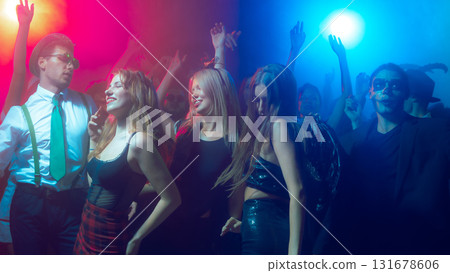 Woman in sparkling top enjoying music at festive party Woman in sparkling top enjoying music at festive party 131678606
