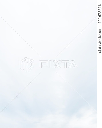 A vertical background image of a pale, bright white-gray cloudy sky with rain clouds spreading A vertical background image of a pale, bright white-gray cloudy sky with rain clouds spreading 131678818