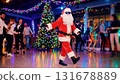 Cool Santa dancing at a Christmas party. music, and joyful moments and fun. Christmas party, Christmas tree, ana Christmas tree light. Enjoy a festive evening party 131678889