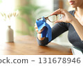 Woman hands cleaning eyeglassed with a cloth at home 131678946
