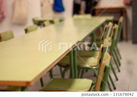 Empty classroom with green chairs and long table 131679042
