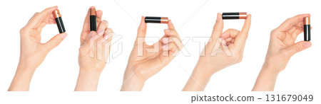 Set of human hands holding battery isolated on transparent background Set of human hands holding battery isolated on transparent background 131679049